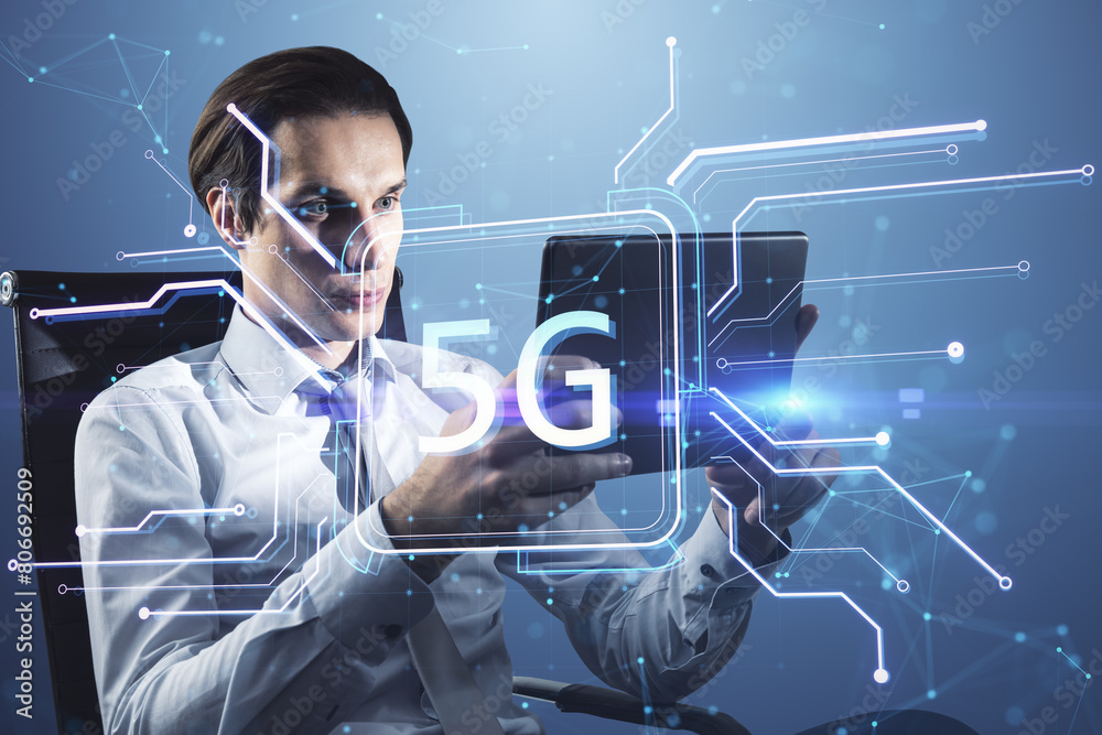 Poster attractive young businessman using tablet with creative square circuit button hologram with 5g icon.