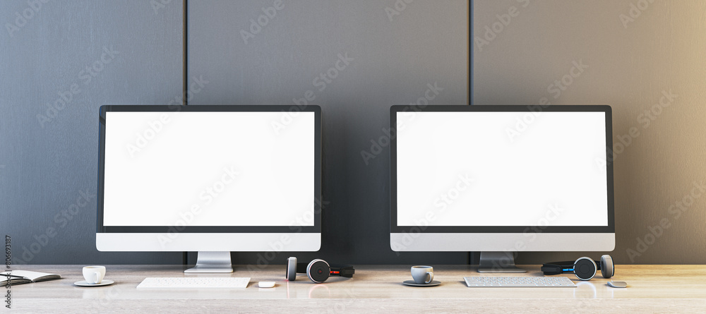 Poster Two empty white gaming computer displays on table with coffee cups and headsets. Place for your advertisement. Gaming club concept. Mock up, 3D Rendering.