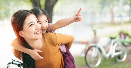 Happy asian mother having fun with her daughter outdoor - Family and love concept