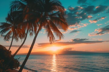Golden sunset over tropical beach with palm trees
