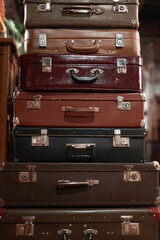 Set of old suitcases. Vintage travel bags.  A Stack of old suitcases in a second-hand store