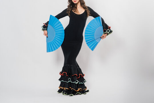 Portrait of beautiful young woman dancing flamenco in studio