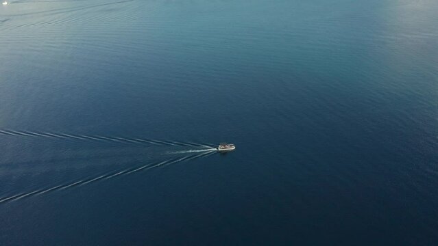 Drone tracking footage of a boat riding in redfish lake surrounded by blue water