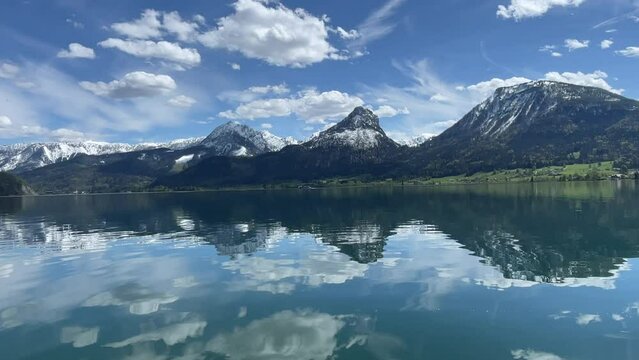 View on empty Lake Wolfgangsee in summer with austrian alps and mountains in background. Region Salzkammergut in Sankt Wolfgang, Austria.
