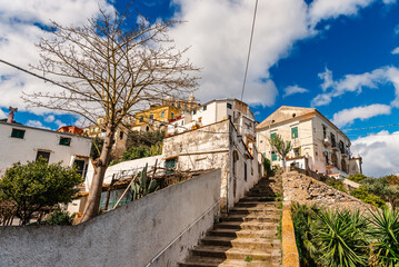 An Italian village. Stairs and white buildings on the hill