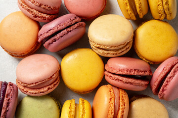Macarons cookies, stack of french macarons on bright background. Sweet dessert, sugar