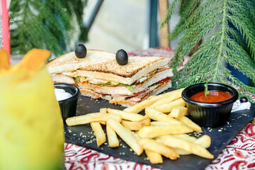Sandwich and French Fries on Wooden Table