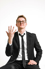 Funny guy in a black suit on a white background. Concept of lightness and elegance