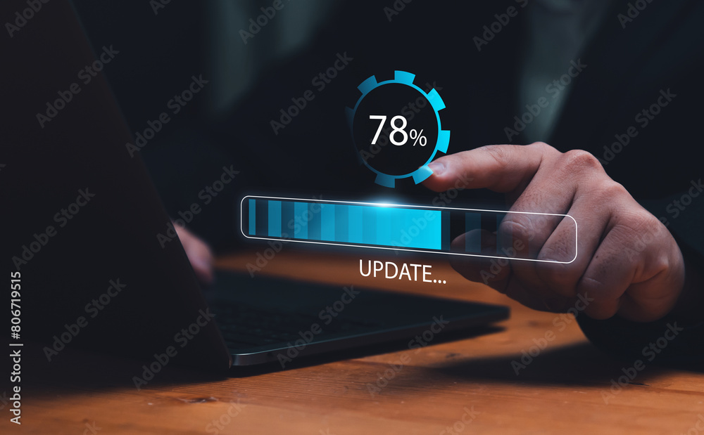Fototapete Businessman updating computer system for device operating system to be up to date with new version. Graphics icon showing updating function screen loading on computer laptop.