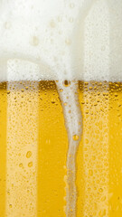 Macro shot pouring cold beer in glass