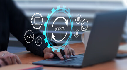 Businessman updating computer system for device operating system to be up to date with new version. Graphics icon showing updating function screen loading on computer laptop.