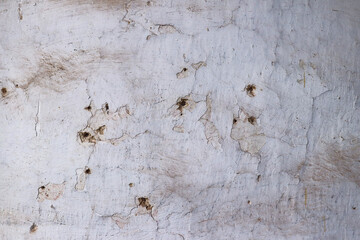 Holes in an old dirty wall