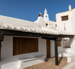 Binibeca Vell, picturesque and charming town in Menorca. Cobblestone streets, all whitewashed houses, low-rise wooden balconies. A jewel bathed by the crystal clear waters of the island, Spain