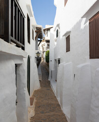 Binibeca Vell, picturesque and charming town in Menorca. Cobblestone streets, all whitewashed houses, low-rise wooden balconies. A jewel bathed by the crystal clear waters of the island, Spain