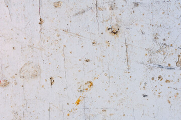 The texture of an old wooden surface covered with white paint
