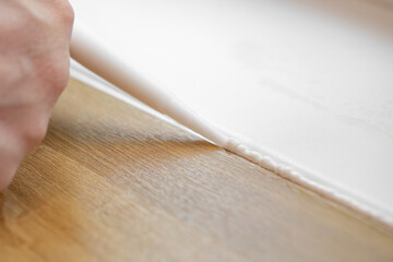 master of interior decoration, smears the joint of the tile and the kitchen countertop with white...