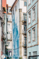View of a street with different and typical facades with colored tiles in the Portuguese city of Porto, Portugal.