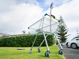 Empty shopping trolley abandoned on the lawn. Auckland.