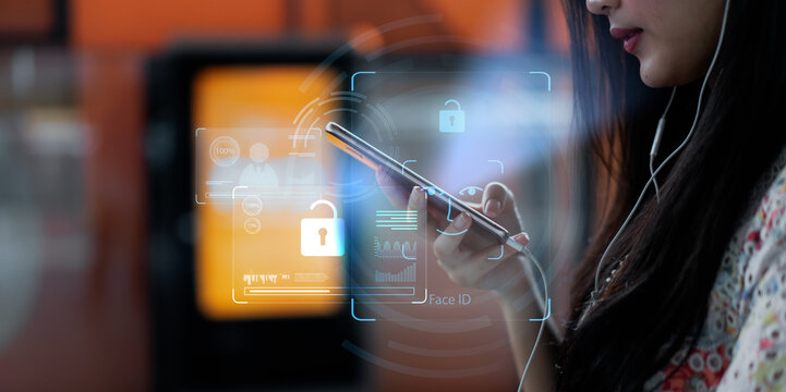Asian female using mobile smartphone scanning  face ID to unlock phone security access with facial recognition technology for biometric identification, future home living luxury tech.