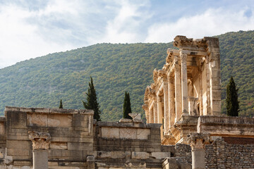 Ancient Celsus Library in Ephesus with its grand facade against a hillside, perfect for historical...