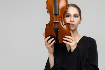 Woman musical artist holding violin