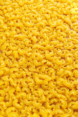 Background of Italian pasta Creste Di Gallo dry. Rooster scallop. Vertical orientation.