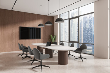 Beige office interior with meeting table and chairs, tv screen and window