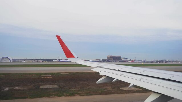 Airplane Airbus A321 ready for take off at airport in the morning. View through airplane window to the wing. Ready to travel , aviation plane operation process. High quality 4k footage