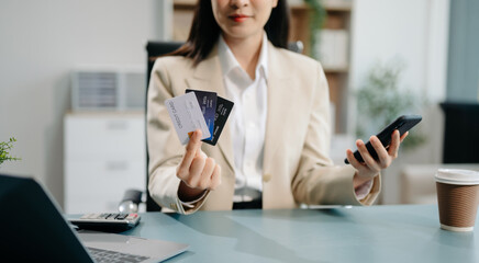 Financial owe, hand of asian woman sitting, holding credit card, stressed by calculate expense from...