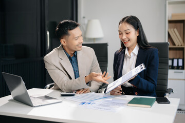 Fototapeta premium Female discussing new project with male colleague. Young woman talking with young man in office..