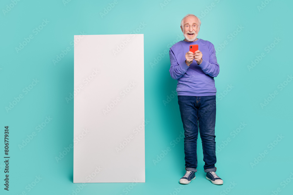 Sticker Full length portrait of cheerful handsome person arms hold use telephone empty space display isolated on teal color background