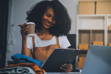 Startup SME small business entrepreneur of freelance Asian woman wearing apron using laptop and box...