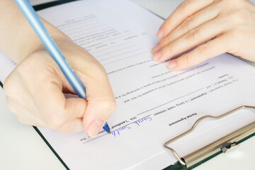 Rental agreement, hand fills out a document, real estate agent, apartment lease