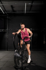 Man exercising on elliptical cross-trainer machine, wearing activewear. Routine workout for physical and mental health.