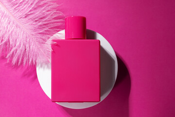 Pink perfume on the podium with soft feather, trendy packaging, essential aroma, modern glamour