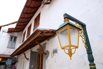 An elegant Vintage street lamp hanged on a white wall
