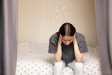 teenager has headache, young woman with troubled expression, indoor stress, teenage distress