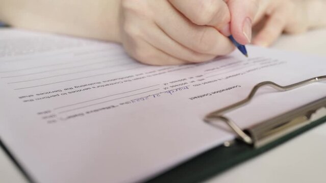 Construction contract, hand fills out a document, engineer assessing project specifications, client confirming work scope