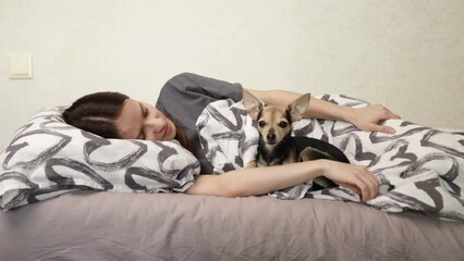 Teenage student sleeping with a dog, cosy bed, comfortable rest, sleeping together, relaxation at home
