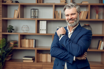 Friendly middle aged man psychotherapist wearing formal wear posing and smiling