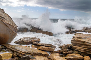 Waves crashing on rock at Coogee Beach, Sydney, New South Wales, Australia
