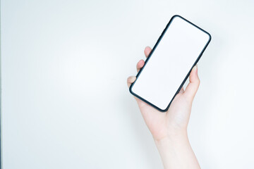 contactless in new normal concept from woman hand hold and smart phone with white isolated background