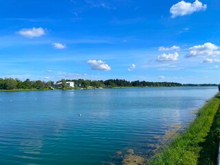 View of the lake and blue clouds on a warm sunny day. Idroscalo park in Milan, Italy A popular park with a lake for swimming, boating and fishing, and an entertainment area for children