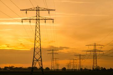 Power lines on a dutch landscape at the sunset.