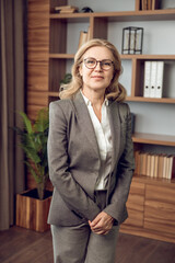 Confident female psychologist in formal wear in modern office