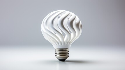 A white light bulb glowing on a white surface