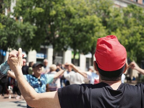 Close-up of a sardanista dancing sardanes, a catalan typical dance, and wearing a traditional catalan hat called barretina