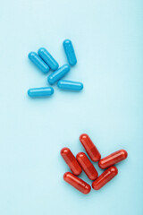 Red and Blue pills on blue background. Choice concept.