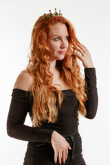 Young beautiful red-haired woman wearing a crown on a light background - 806804305