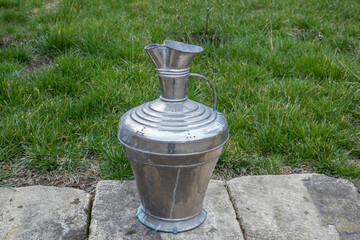 Antique metal vessels for water and wine. A copper jug in an ancient fortress. Antique handmade...